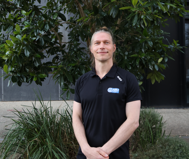 Photo of a man wearing an ANU Sport shirt