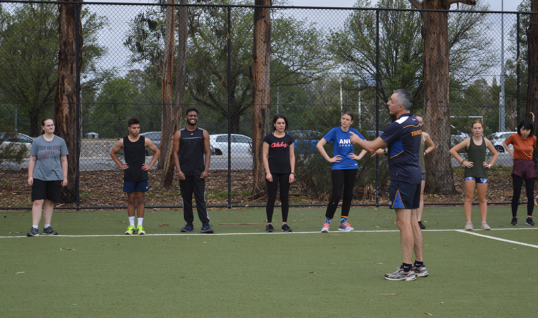 Instructor talking to class on an oval